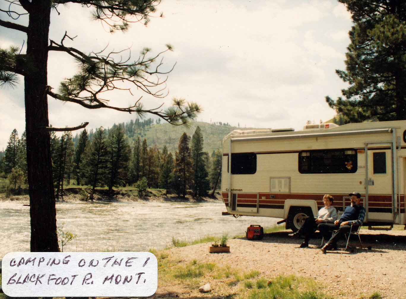 Photo of Mom and Dad in front of the camper