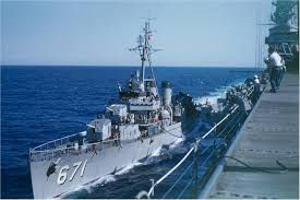 USS Gatling along side aircraft carrier